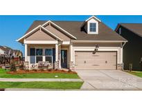 Craftsman style home with gray siding, a two-car garage, and a welcoming front porch at 1118 Lowland Way, Waxhaw, NC 28173