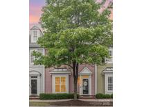 Charming townhome exterior with light pink siding and welcoming front porch at 13616 Morehouse St, Huntersville, NC 28078