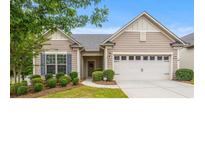 Charming single-story home featuring manicured landscaping, a two-car garage and a welcoming entrance at 984 Kirby Dr, Fort Mill, SC 29715