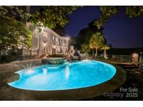 Inviting backyard pool and hot tub area with ambient lighting for evening enjoyment at 1873 Farrow Dr, Rock Hill, SC 29732