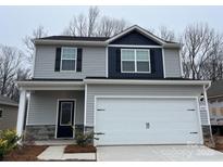 Two-story house with gray siding, white garage door, and stone accents at 3532 Clover Valley Dr, Gastonia, NC 28052