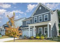 Two-story house with gray siding, white trim, and a two-car garage at 1390 Cedardale Ln, Denver, NC 28037