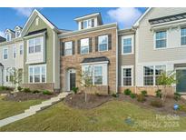 Modern three-story townhome with landscaping at 939 Cobbled Way, Fort Mill, SC 29715