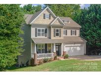 Two-story house with a brick facade, attached garage, and a well-maintained lawn at 121 Canvasback Rd, Mooresville, NC 28117