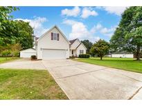 Charming two-story home with a well-manicured lawn, a two car garage, and a long driveway at 416 Linsbury Ct, Gastonia, NC 28056