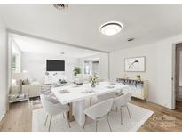 Bright dining room features a white table with seating for six and an open concept layout at 217 Burrage Ne Rd, Concord, NC 28025