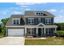 Charming two-story home with gray siding, white trim, and a well-manicured lawn at 5735 Allburn Pkwy, Concord, NC 28027