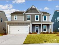 Two-story house with gray siding, white garage door, and landscaping at 2074 Van Buren Rd, Sherrills Ford, NC 28673