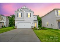 Charming two-story home with a well-manicured lawn and a two-car garage at 1007 Freeman View Dr, Albemarle, NC 28001