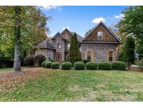 Brick two-story house with landscaped lawn and mature trees at 4800 Pimlico Ln, Waxhaw, NC 28173