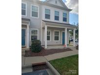 Two-story townhome with gray siding, front porch, and landscaping at 13969 Clayborn St, Midland, NC 28107