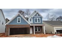 Two-story craftsman style home with gray siding and brick accents at 143 Ella Claire Dr # 004, York, SC 29745