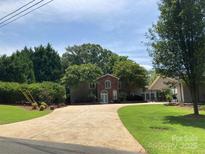 Charming brick and siding home with mature trees and a spacious driveway at 24756 Strand Dr, Albemarle, NC 28001