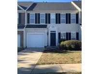 Charming townhouse featuring black shutters and a one-car garage for convenient parking at 4016 Holly Villa Cir, Indian Trail, NC 28079