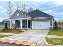 Charming single-story home with a well-manicured lawn, white garage door, and inviting front porch at 515 Tates Trl # 39, Cramerton, NC 28032