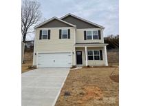 Charming two-story home with a two-car garage, black shutters, and a well-manicured lawn at 116 Rustling Waters Dr, Mooresville, NC 28117
