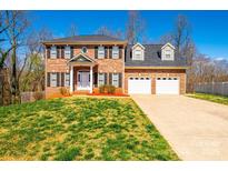 Lovely two-story brick home featuring a well-manicured lawn and an attached three-car garage at 2640 Ironwood Dr, Hickory, NC 28602