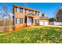 Charming two-story home with a brick facade, three-car garage, and manicured lawn at 2640 Ironwood Dr, Hickory, NC 28602
