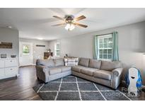 Spacious living room featuring a comfortable sectional sofa and wood-look floors at 335 Adolphus Rd, Salisbury, NC 28146