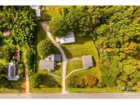 Expansive aerial view of property featuring multiple structures amidst lush greenery and a long driveway at 5960/5930 S Main St, Salisbury, NC 28147