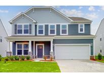 Charming two-story home featuring a two-car garage, covered porch, and well-maintained landscaping at 649 Kitfox Nw Dr, Concord, NC 28027