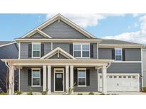 Charming two-story home with gray siding, a covered front porch, and manicured landscaping at 317 Miramar Dr, York, SC 29745
