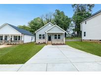 Charming single-story home features a well-manicured lawn and a welcoming front porch with brick accents at 602 Meadow Ave, Spencer, NC 28159