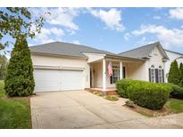 Charming single-story home featuring a two-car garage and a well-manicured front lawn at 8511 Castledown Dr, Huntersville, NC 28078