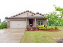 Charming brick home featuring a well-maintained lawn and a two-car garage at 2413 Riparian Way, Denver, NC 28037