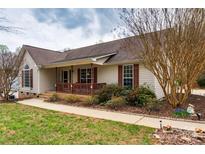 Charming single-story home featuring a welcoming front porch and well-maintained landscaping, set under a cloudy sky at 2511 Old Pond Dr, Lincolnton, NC 28092