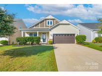 Charming single-Gathering home featuring a manicured lawn, a two-car garage, and inviting curb appeal at 1957 Tablerock Dr, York, SC 29745