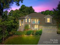 Two-story house with a large front yard, driveway, and attached garage at 141 Red Brook Ln, Mooresville, NC 28117