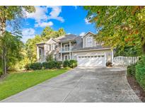 Two-story house with a three-car garage and landscaped lawn at 141 Red Brook Ln, Mooresville, NC 28117