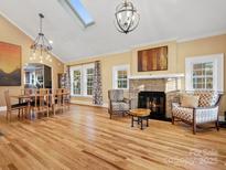 Spacious living room features hardwood floors, fireplace, and large windows at 316 W Kingston Ave, Charlotte, NC 28203