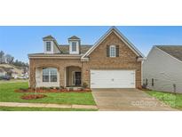 Brick two-story house with a two-car garage and landscaped lawn at 4450 Doyle Ridge Rd, Maiden, NC 28650