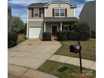 Charming two-story home featuring a garage and well-maintained front yard at 4803 Roxfield Ln, Charlotte, NC 28215