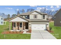 Two-story house with stone accents and a white garage door at 9916 Manor Vista Trl, Kannapolis, NC 28027