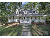 White two-story house with front porch and landscaping at 17929 Pages Pond Ct, Davidson, NC 28036