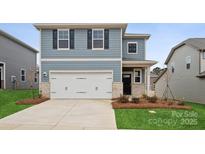 Two-story house with gray siding, white garage door, and landscaping at 538 Mountain View Dr, Monroe, NC 28110