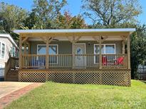 Charming exterior of home with a covered front porch and well-maintained lawn at 102 Elm St # 94, New London, NC 28127