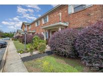 Brick building exterior with landscaping and parking at 1201 Green Oaks Ln # G, Charlotte, NC 28205