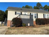 Ranch style home with gray deck and landscaping at 1520 Yellowstone Ct, Gastonia, NC 28054