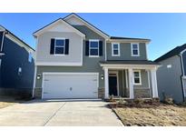 Two-story house with a two-car garage and landscaping at 3018 Cunningham Farm Dr, Indian Trail, NC 28079