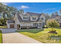 Two-story house with a stone facade, large windows, and a well-maintained lawn at 131 Lakeshore Hills Dr, Mooresville, NC 28117