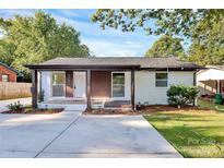 Newly renovated front facade with fresh landscaping and a welcoming porch at 4132 Shamrock Dr, Charlotte, NC 28215