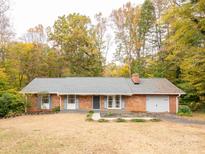 Charming brick home featuring a manicured lawn, classic design, and attached garage at 110 Mimosa Rd, Statesville, NC 28677