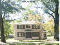 Charming two-story home with landscaped yard featuring mature shade trees at 3111 Sandy Porter Rd, Charlotte, NC 28273