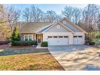 Gray two-story house with double garage and landscaped lawn at 7324 Friar Tuck Ln, Mint Hill, NC 28227