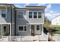 Gray two-story townhome with white fence and patio at 112 Atterberry Aly, Charlotte, NC 28217