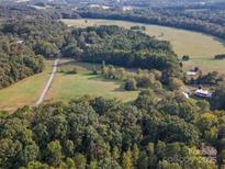 Stunning aerial view showcasing the property's location and surrounding lush greenery at 13079 Philadelphia Church Rd, Oakboro, NC 28129